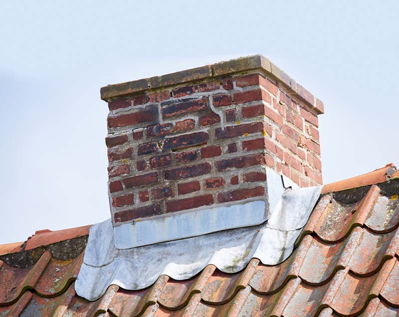 Stock Image - chimney repair -Central Masonry & Chimney Man inspecting carbon monoxide detector