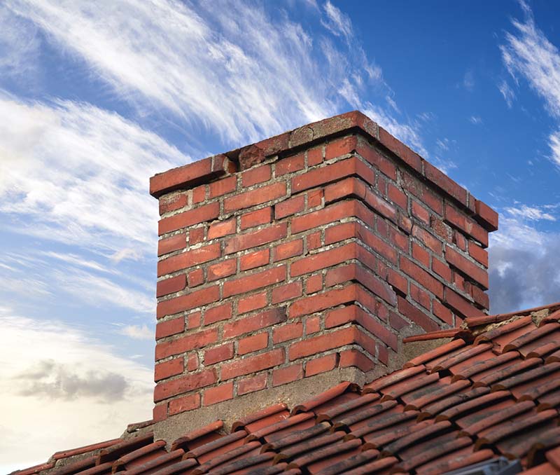 Stock Image - chimney repair -Central Masonry & Chimney brick chimney in need of repair